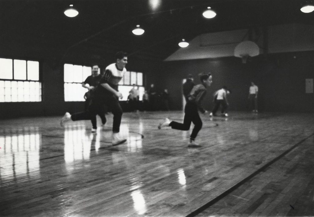 Miniature of Boys running on a basketball court in the gymnasium of the Hull-House Jane Addams Center