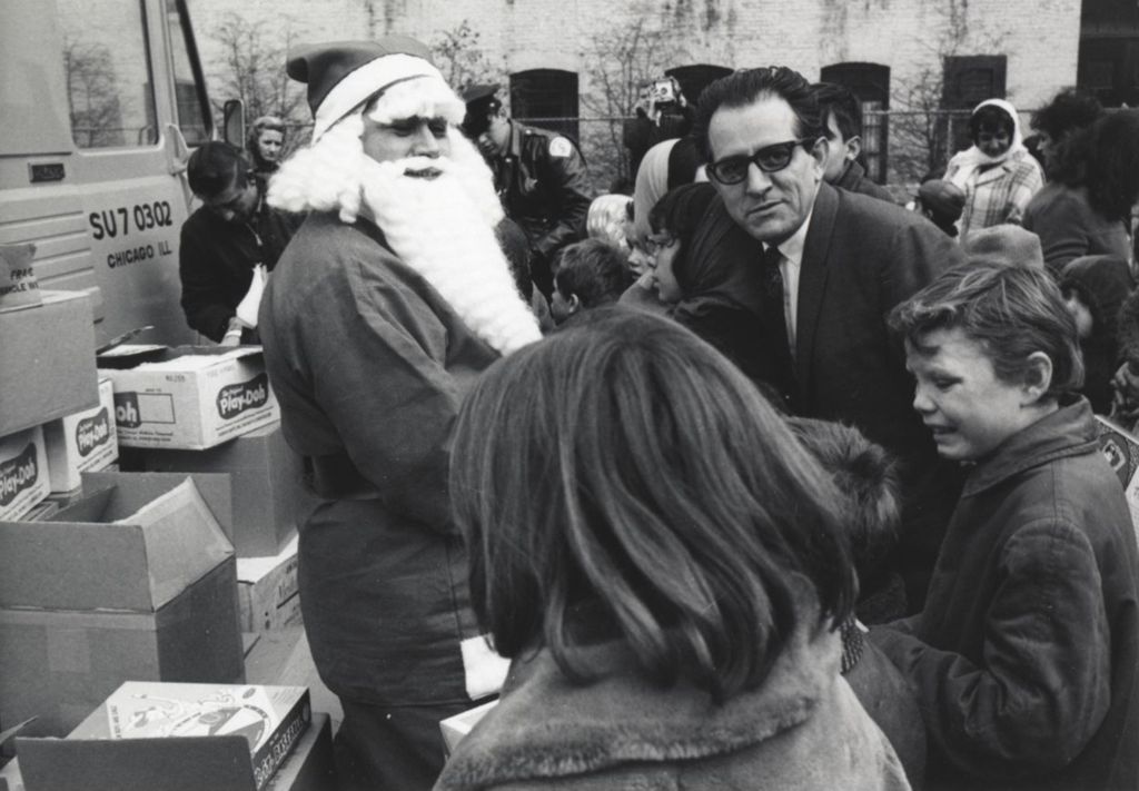 Santa Claus and attendees at a Hull-House Christmas toy giveaway