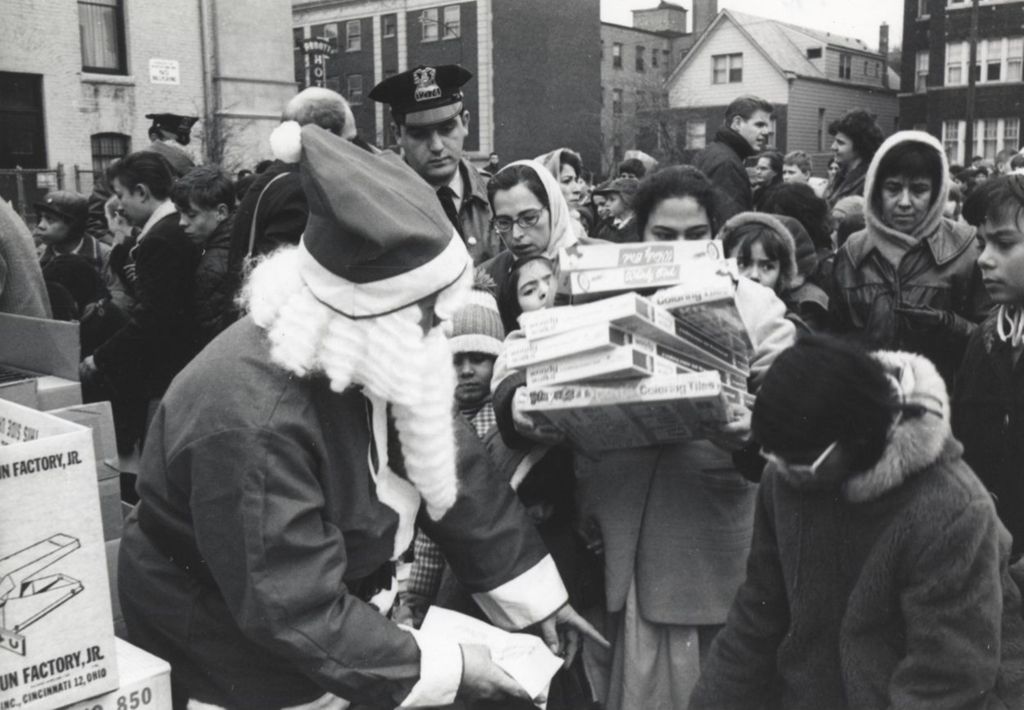 Miniature of Man in Santa Claus costume giving out gifts at a Hull-House Christmas toy giveaway