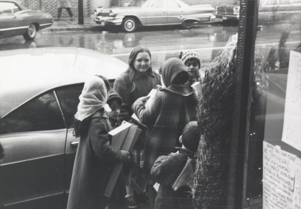 Children with gifts outside of a Hull-House Christmas party at the Jane Addams Center