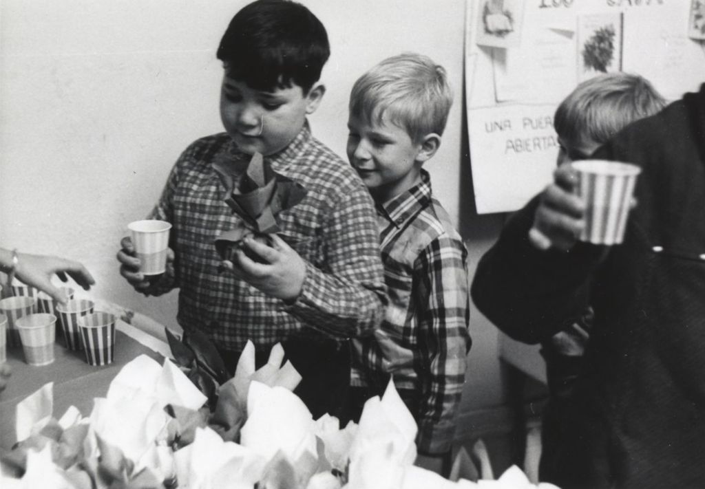 Boys get drinks and treats at a Hull-House Christmas party at Jane Addams Center