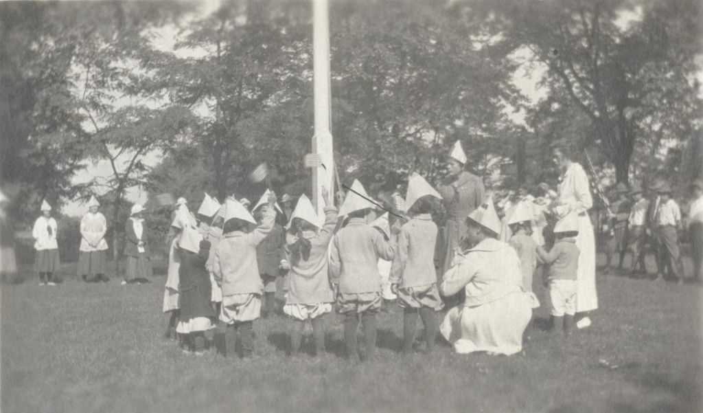 Miniature of Children in paper hats around flagpole