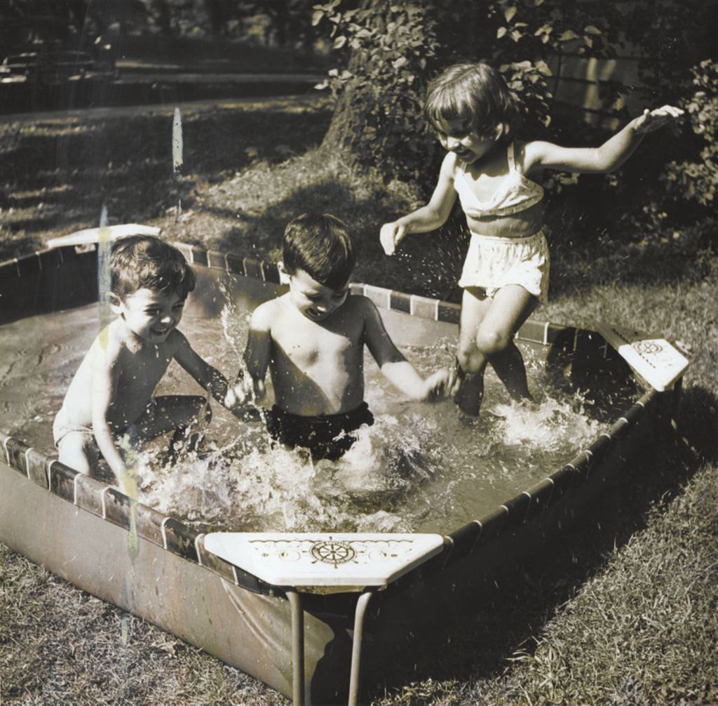 Miniature of Standing girl and two boys playing in wading pool