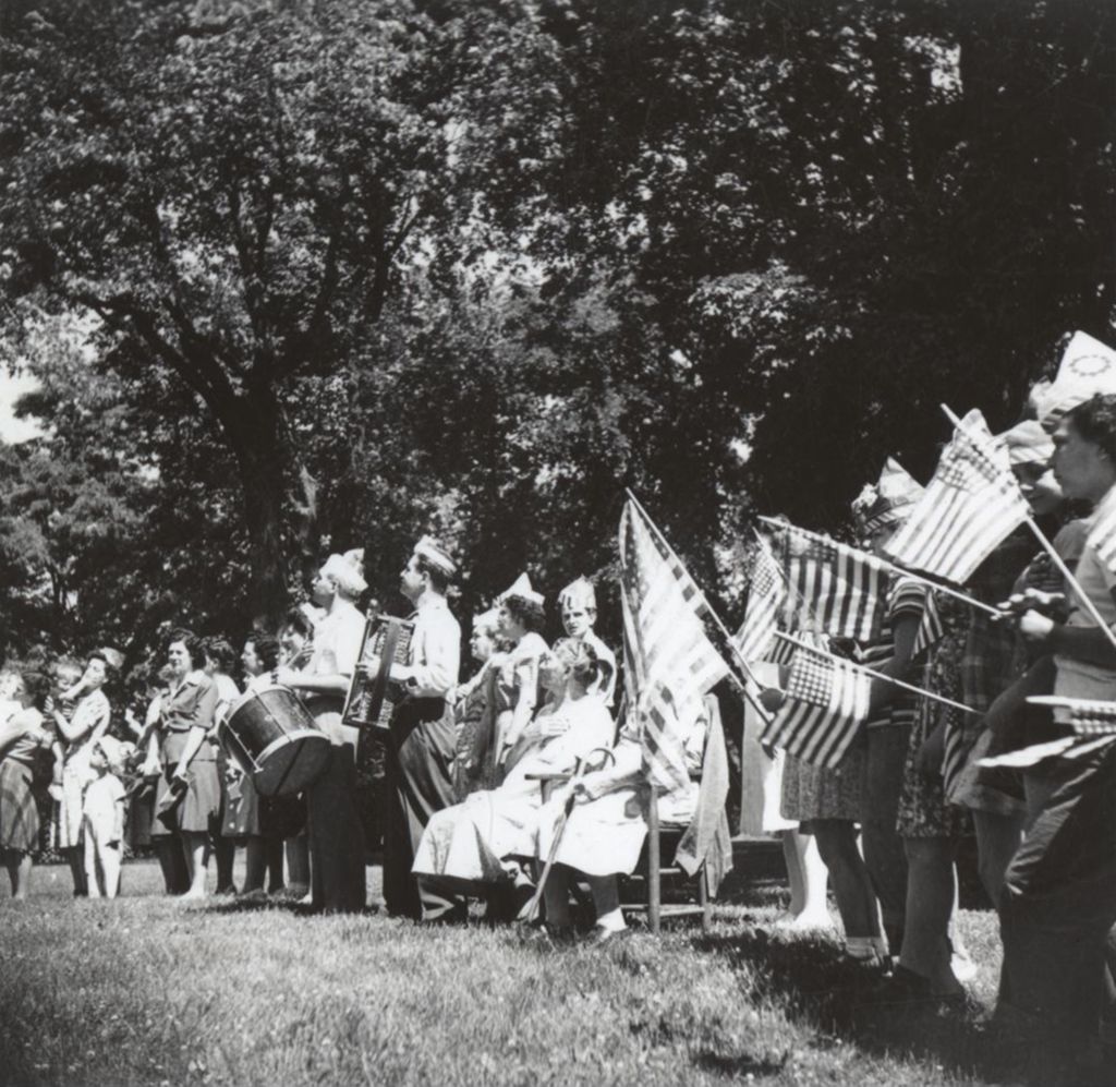 Children with drum, accordion, and flags