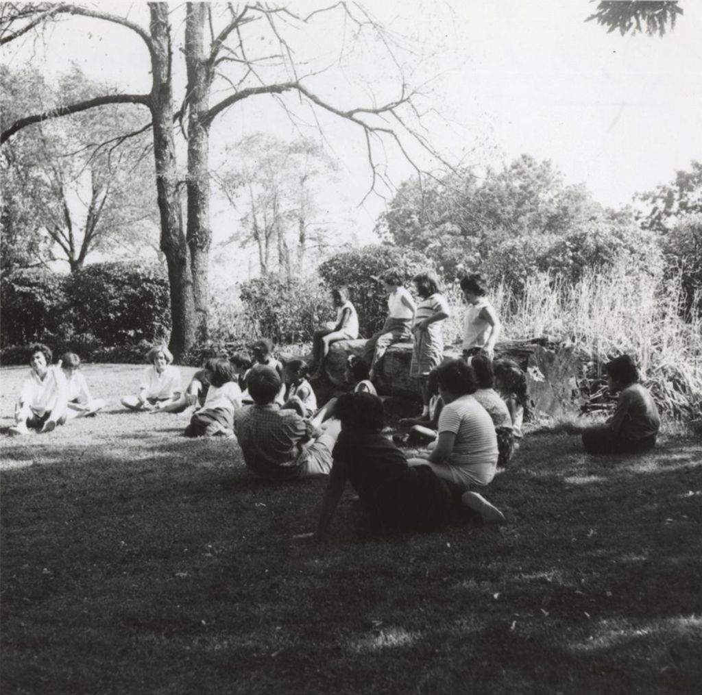 Children and teens sitting on lawn