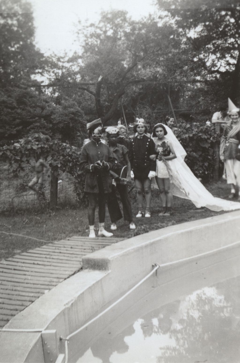Mock wedding procession near pool