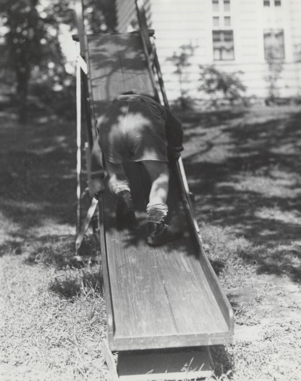 Miniature of Boy climbing up slide