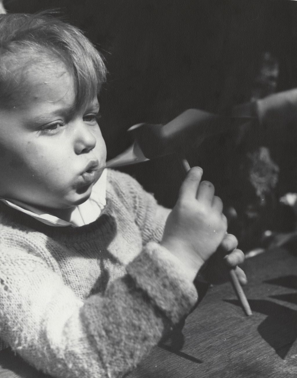 Miniature of Boy blowing on pinwheel