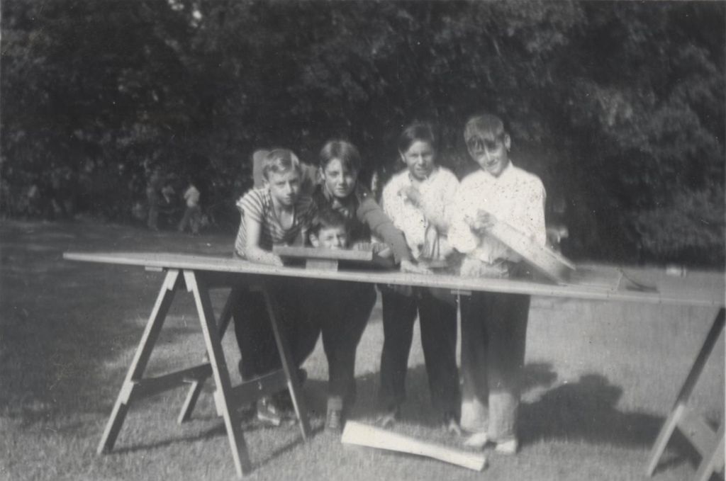 Boys standing at sawhorse table