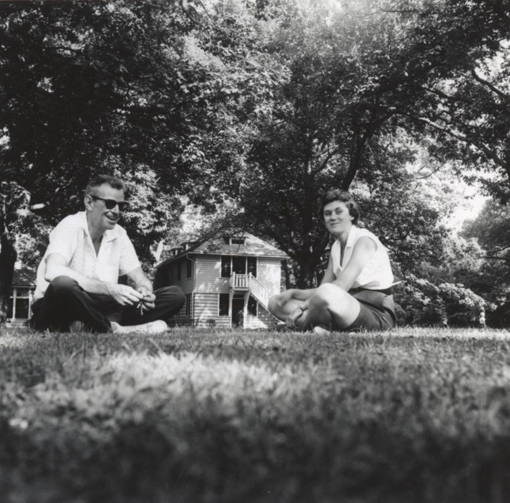 Adults on lawn in front of Smith Cottage