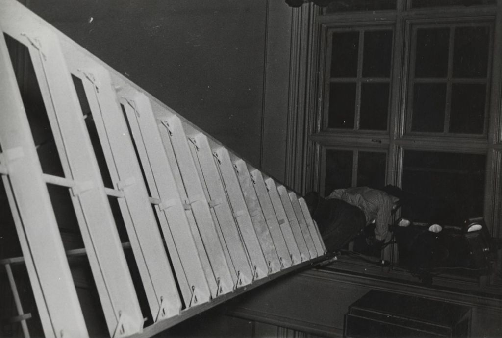 Miniature of Man on ladder working on lighting at Hull-House Auditorium