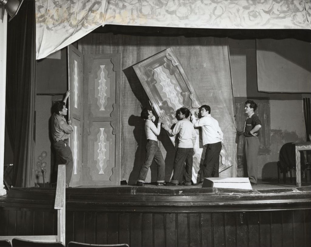 Miniature of Young men constructing a set on stage at Hull-House Auditorium