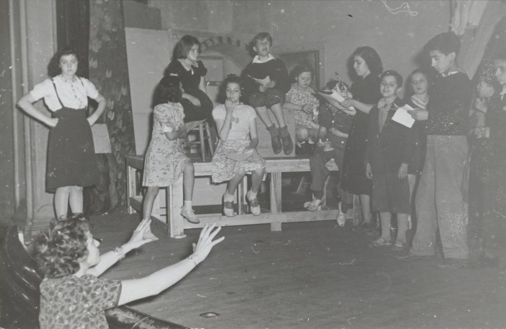 Viola Sills (Spolin) directing members of the Hull-House Junior Theatre Group in a rehearsal of "The Brave Little Tailor"