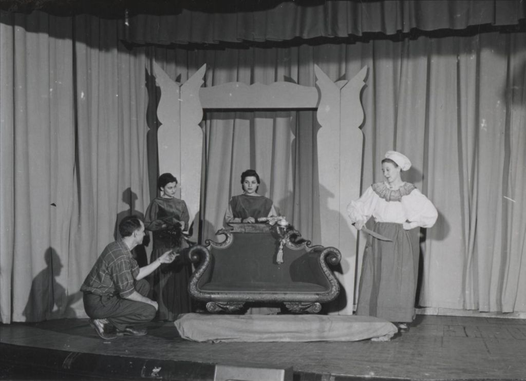Miniature of Hull-House dramatics instructor Hans Schmidt directing actors in "Sleeping Beauty"