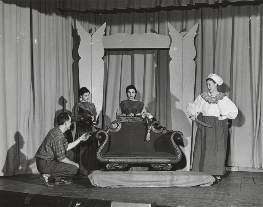Miniature of Hull-House dramatics instructor Hans Schmidt directing actors in "Sleeping Beauty"