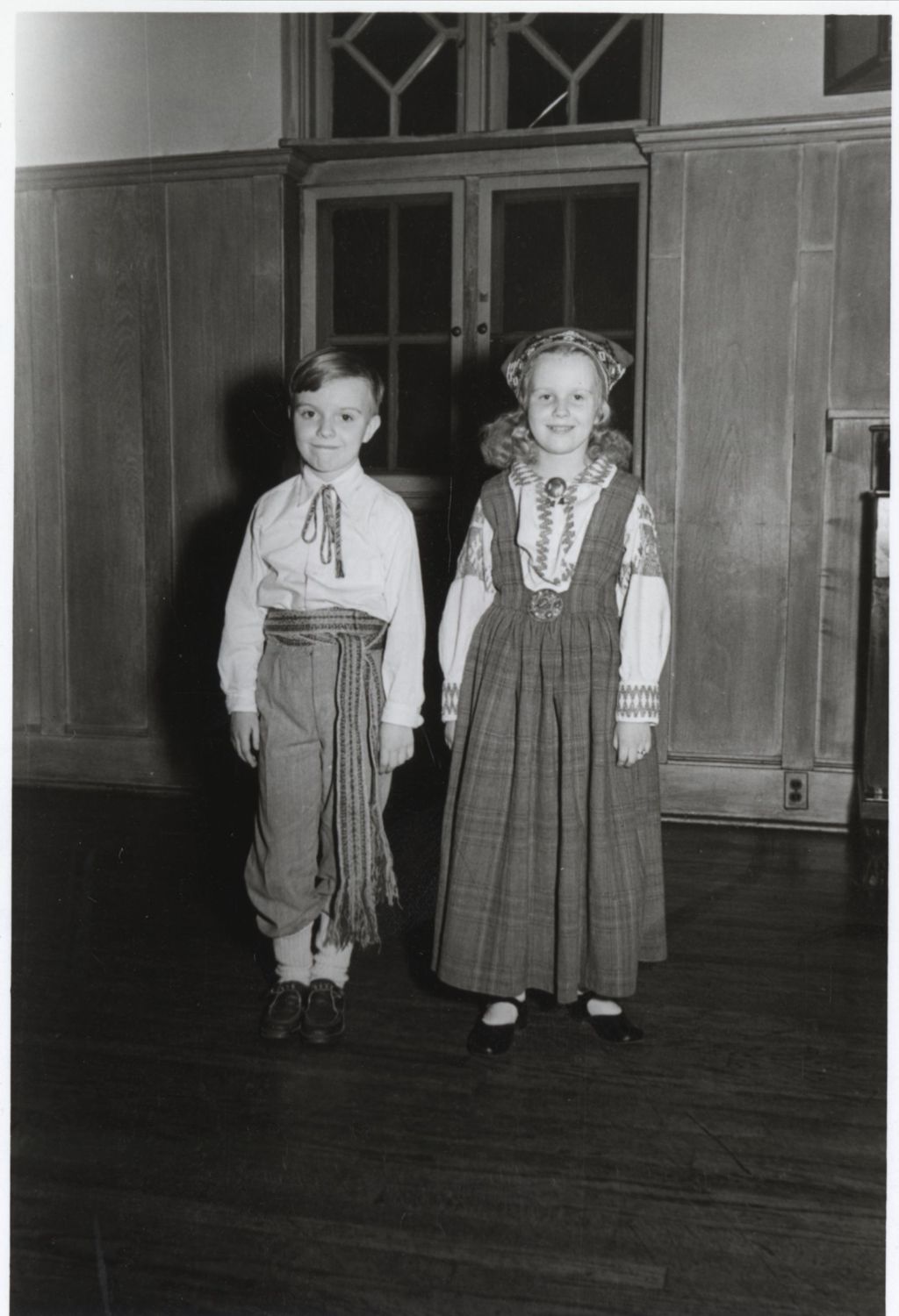 Two children in traditional Latvian clothing at a folk dancing demonstration at the Hull-House 1951 Spring Carnival