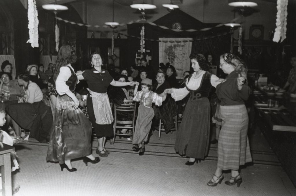 Women and a girl in traditional Greek clothing dancing during Hull-House 1951 Spring Carnival