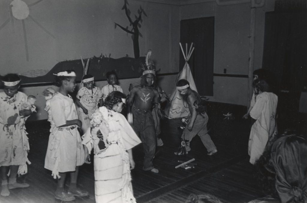 Children dressed in Native American costumes in a theatrical production at Hull-House