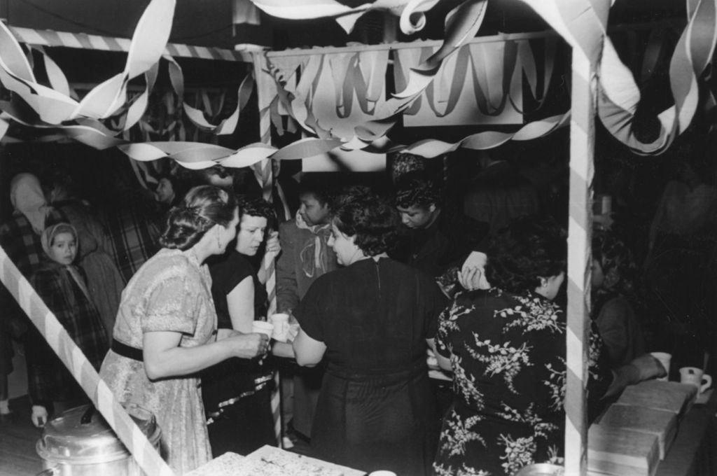 Attendees and staffers at a baked goods booth during Hull-House Carnival