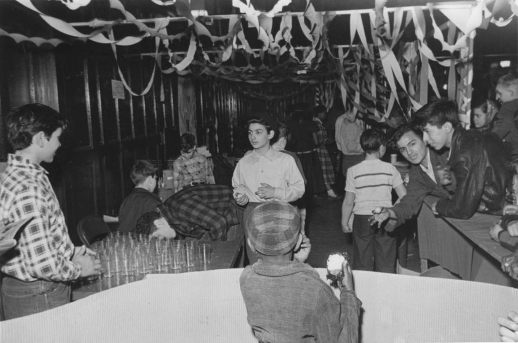 Boys at a ping pong ball toss booth during Hull-House Carnival