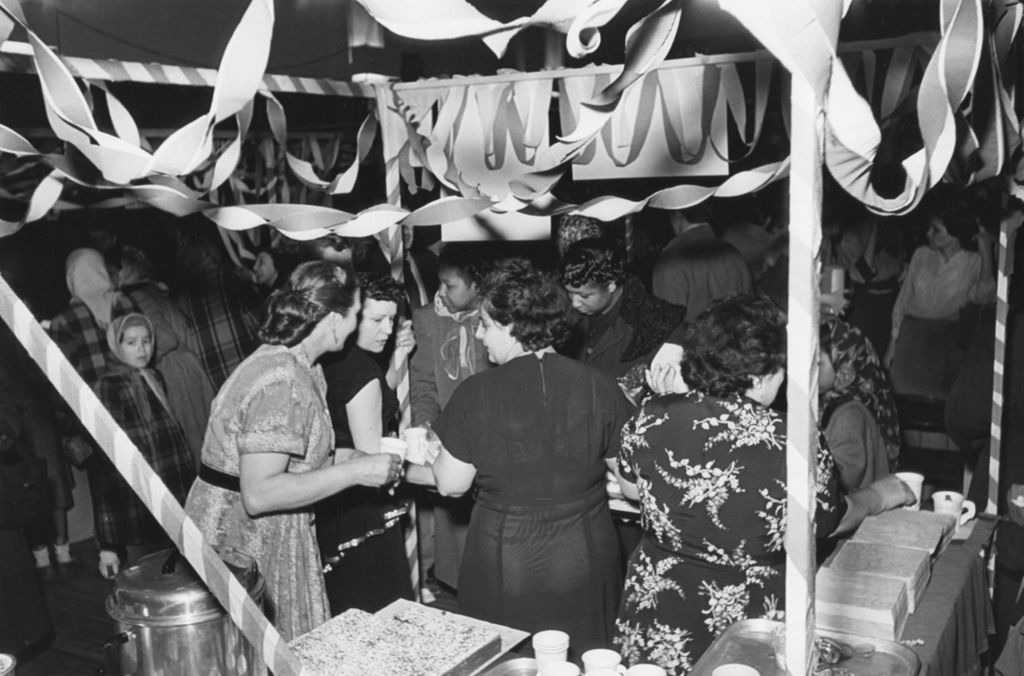 Attendees and staffers at a baked goods booth during Hull-House Carnival