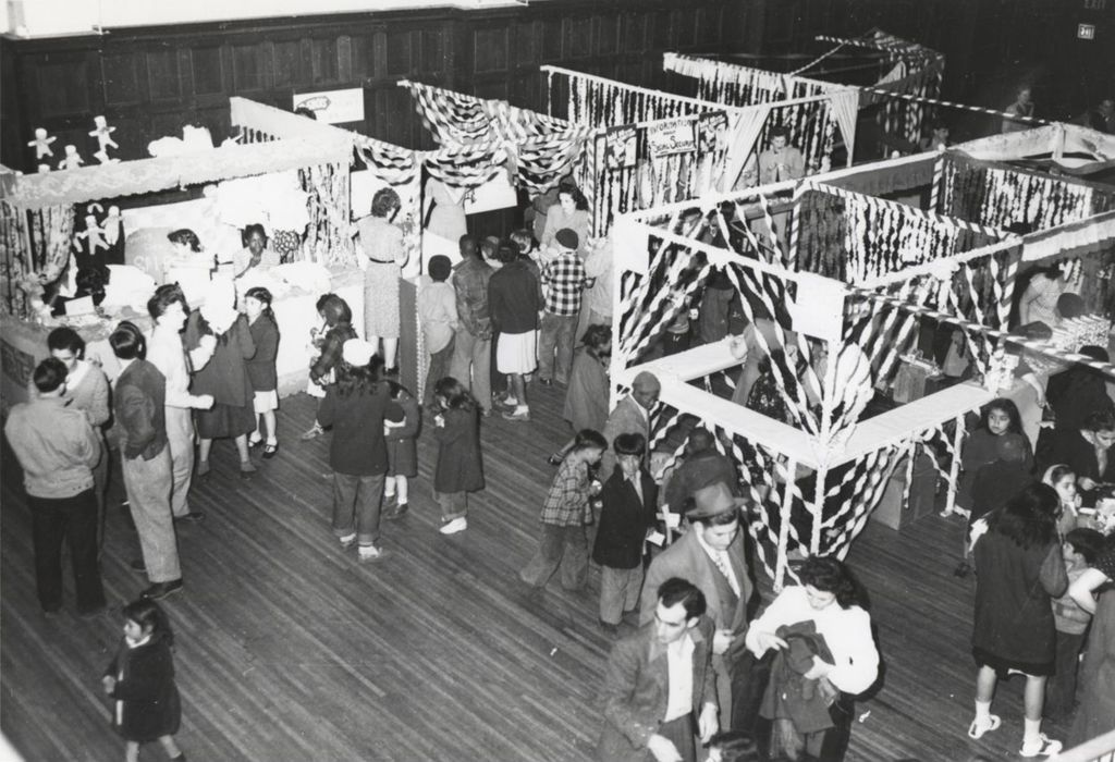 Attendees and staffed booths in Bowen Hall during Hull-House Carnival