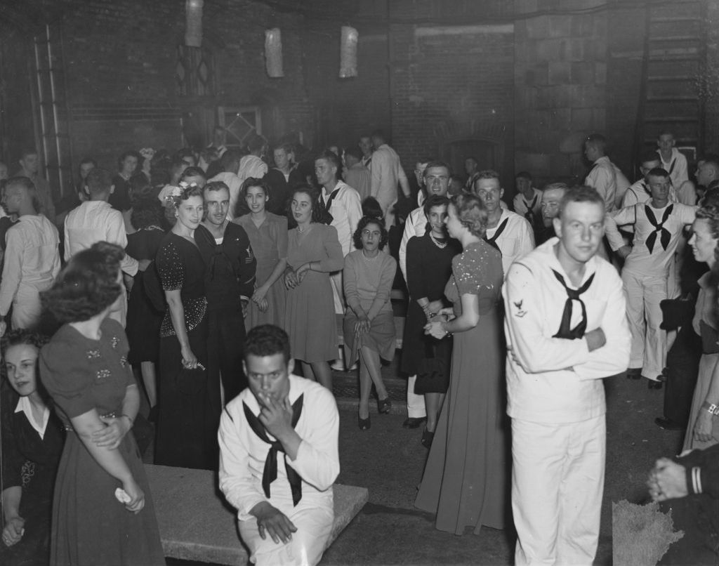 United States Navy sailors and women on the terrace outside the Hull-House Residents' Dining Hall during an "Entertaining the Navy" event