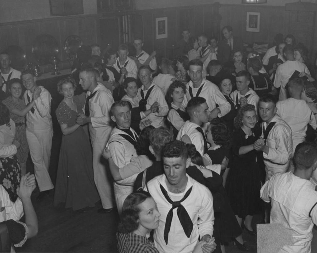 United States Navy sailors and civilian women dancing in pairs in the Hull-House Residents' Dining Hall during an "Entertaining the Navy" event