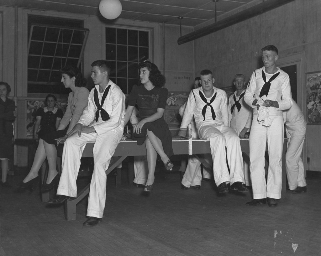 United States Navy sailors and civilian women in a game room at Hull-House during an "Entertaining the Navy" event