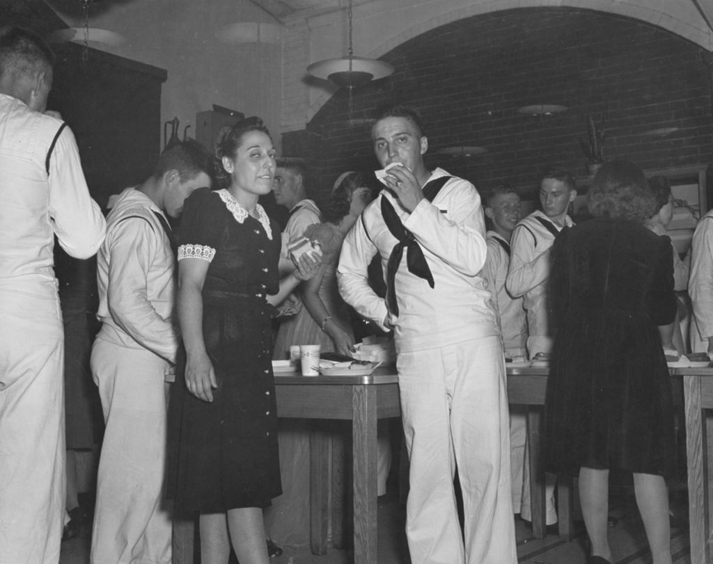 Miniature of A civilian woman and a United States Navy sailor having a bite to eat in the Hull-House Coffee House during an "Entertaining the Navy" social event