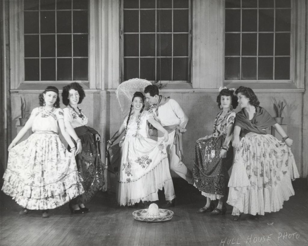 Six dancers in traditional clothing pose as part of Mexican Fiesta at Hull-House