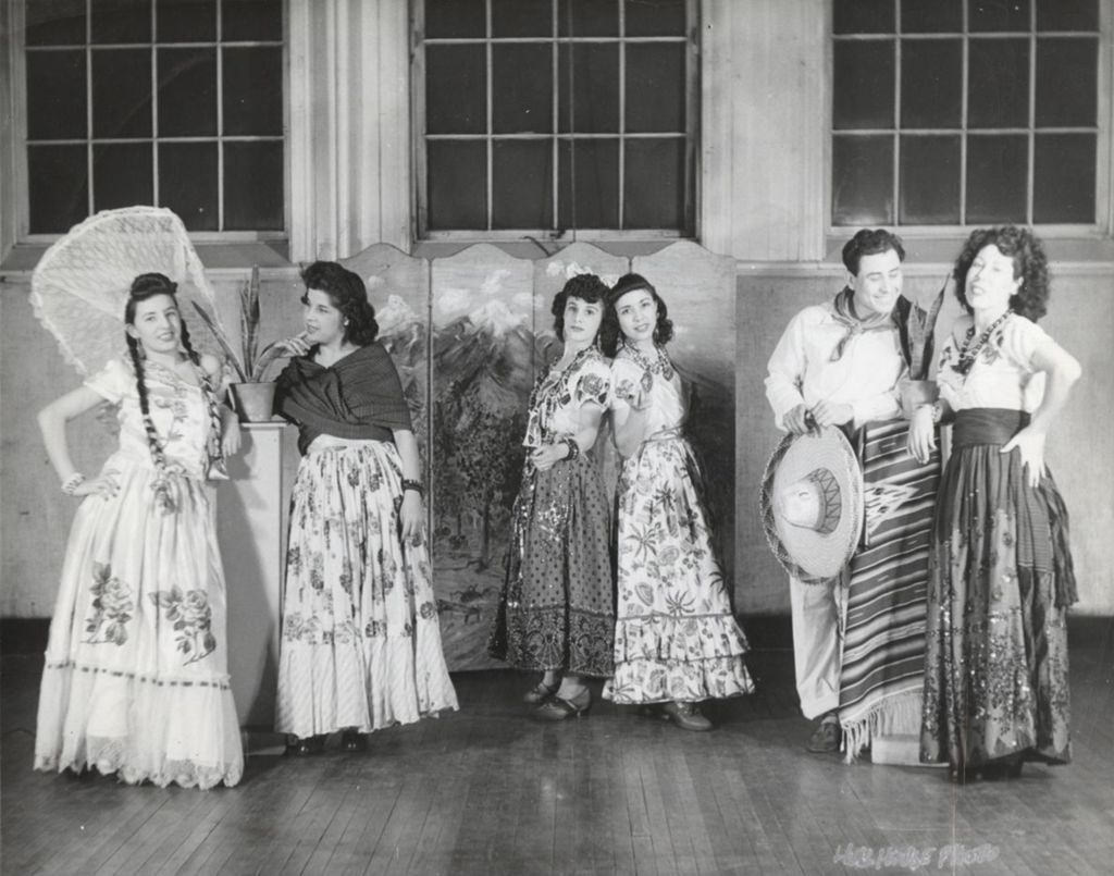 Six dancers in traditional clothing pose as part of Mexican Fiesta at Hull-House