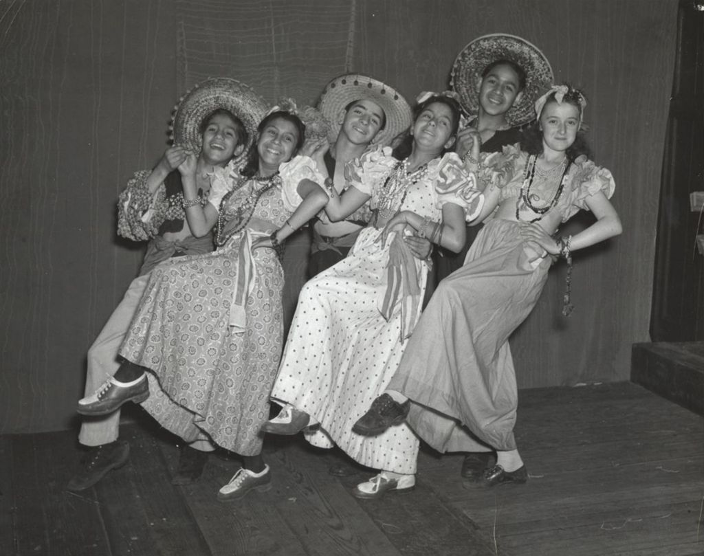 Six young dancers in traditional Mexican clothing performing at the 1942 Hull-House Associates annual meeting