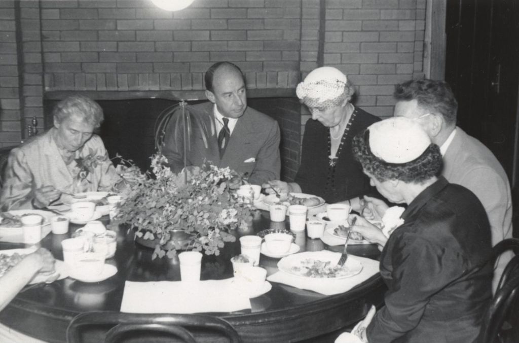 Miniature of Hull-House resident Jessie Binford, Illinois governor Adlai Stevenson II, Hull-House board president Alma Petersen, Hull-House director Russell Ballard, and an unidentified woman eating around a table at Hull-House