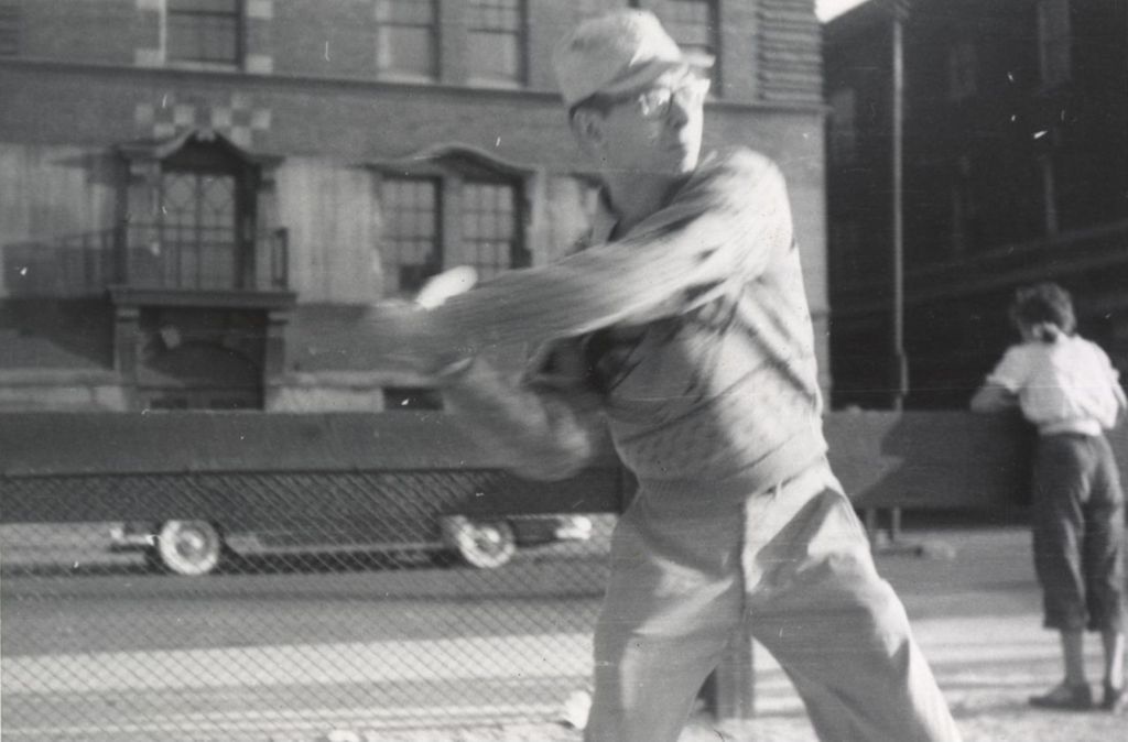 Miniature of Man swinging a baseball bat across the street from Hull-House