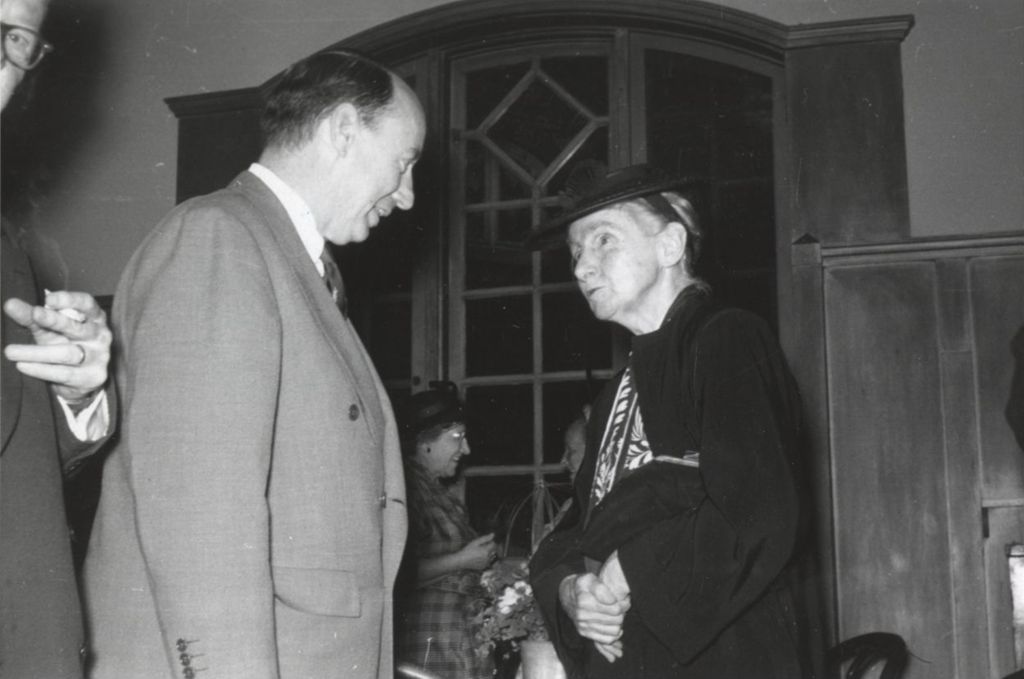 Miniature of Illinois governor Adlai Stevenson II and Hull-House resident Edith Abbott talking at a reception at Hull-House