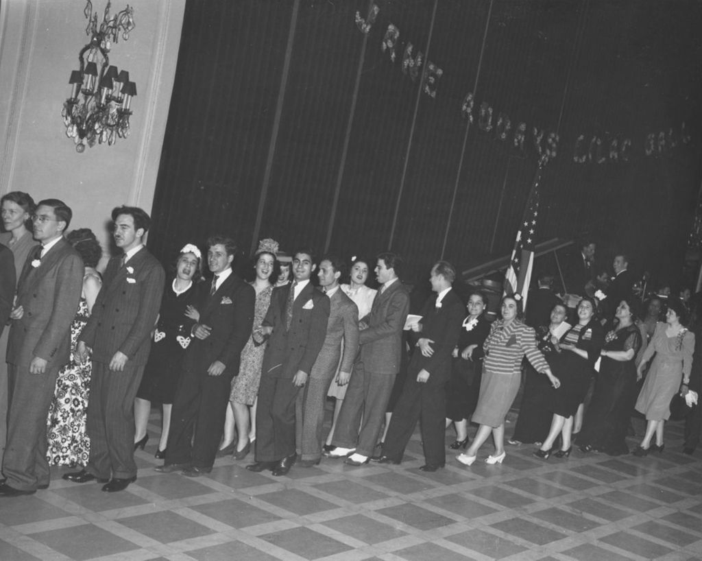 Pairs of attendees in a line at the 1941 Lilac Ball at the Stevens Hotel