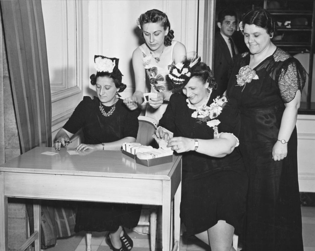 Miniature of Women at a reception desk at the 1941 Lilac Ball at the Stevens Hotel