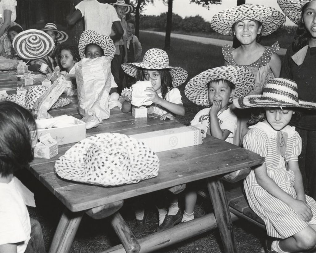 Children from Hull-House around a picnic table during a trip to Hawthorn-Mellody Farms