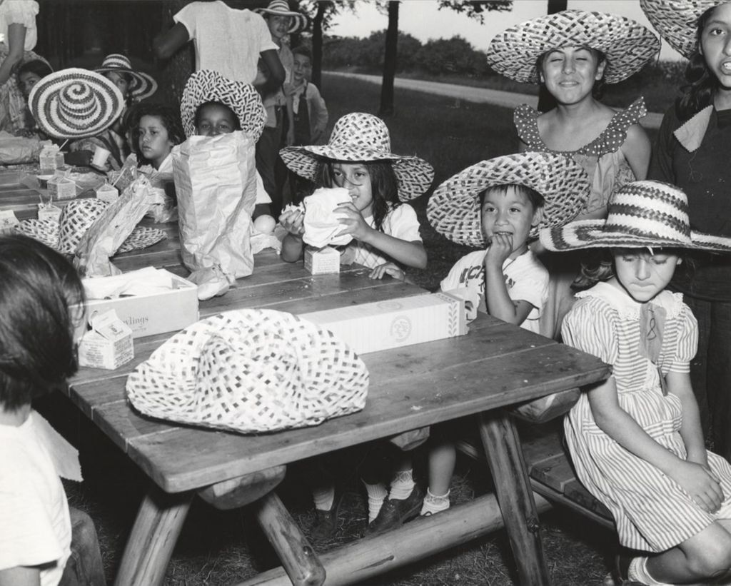 Children from Hull-House around a picnic table during a trip to Hawthorn-Mellody Farms