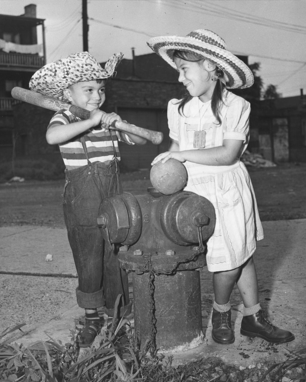 Miniature of Boy and a girl standing next to a fire hydrant with a bat and softball
