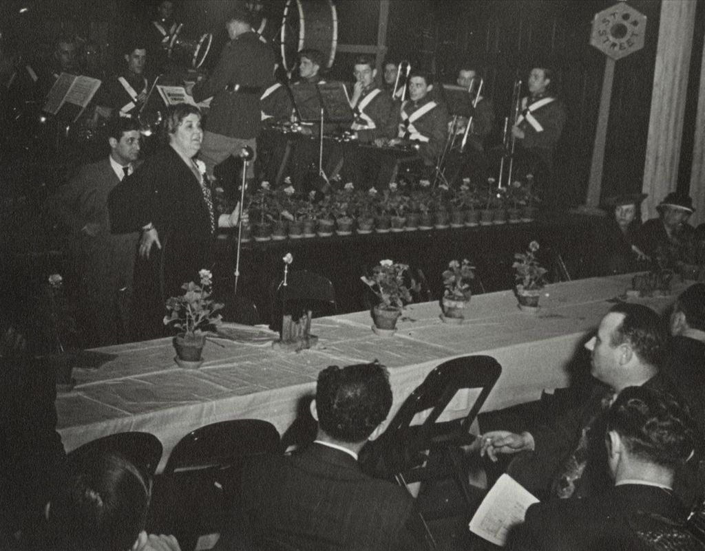Miniature of Hull-House director Charlotte Carr addressing the audience at the 1940 Alumni Dinner, part of the 50th Anniversary celebration