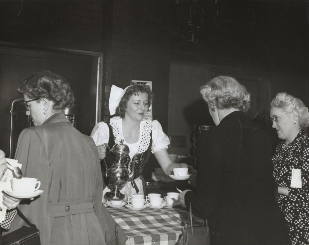Woman serving coffee at an event celebrating the Hull-House 50th Anniversary
