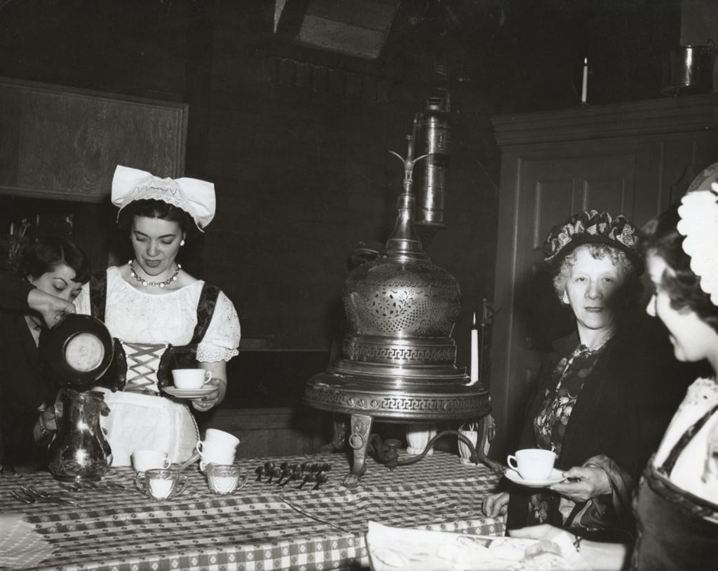 Hull-House employee Camille Ippolito and others serving coffee at an event celebrating the Hull-House 50th Anniversary