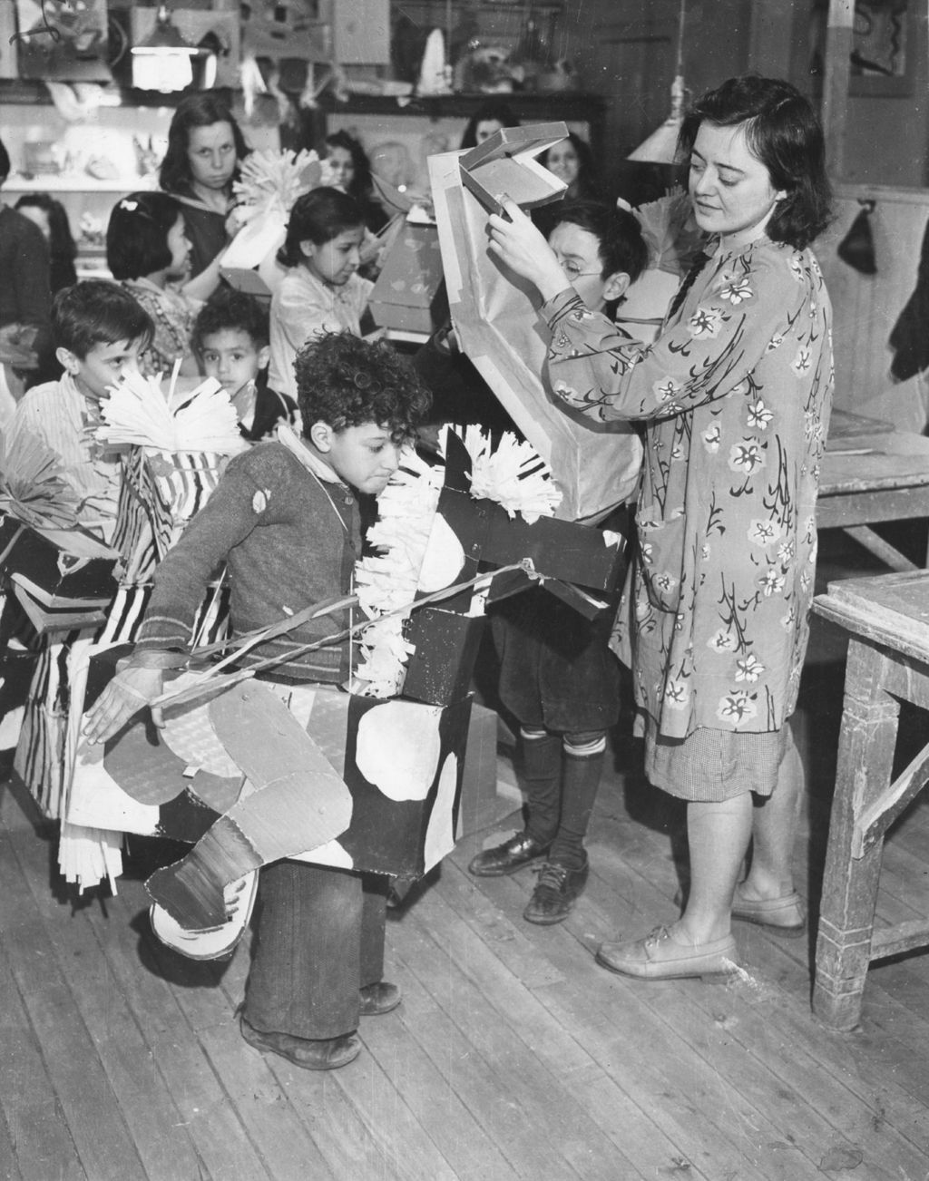 Hull-House instructor Branka Cuculic helps children prepare horse costumes for 50th Anniversary circus