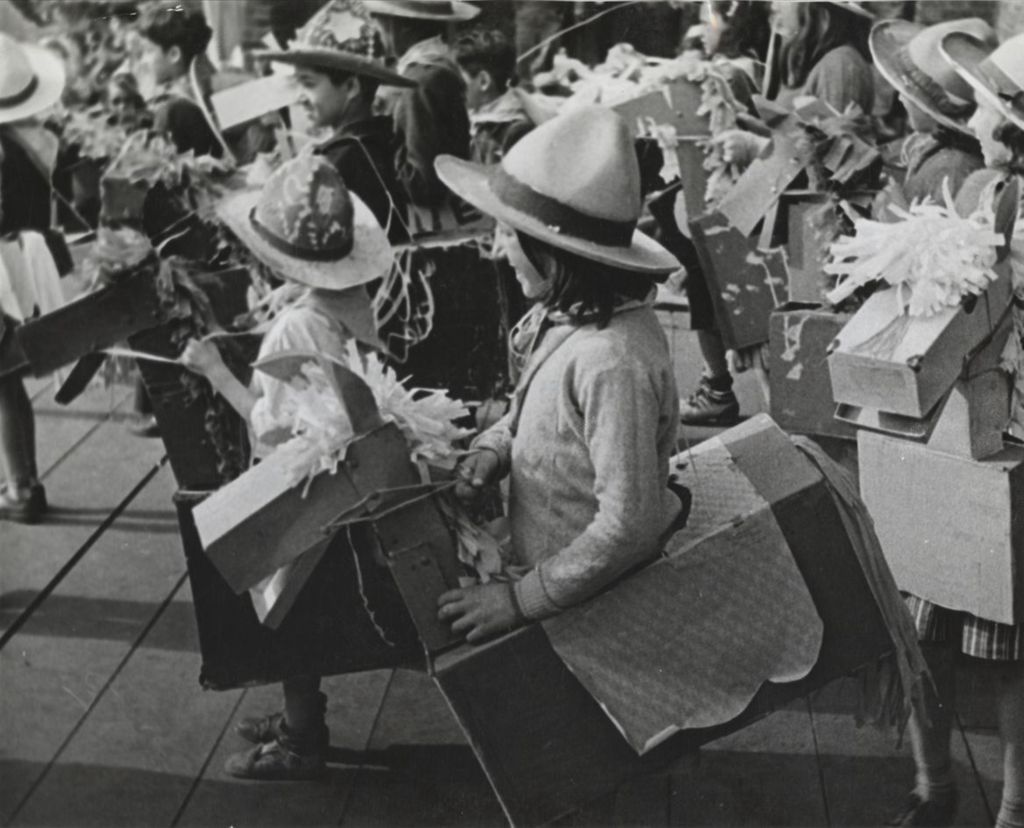 Miniature of Young people on stage wearing cardboard horse costumes around their waists as part of Hull-House 50th Anniversary circus show
