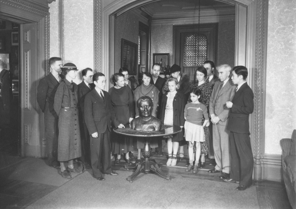 Miniature of Group of Hull-House residents and others standing around a bust of Jane Addams