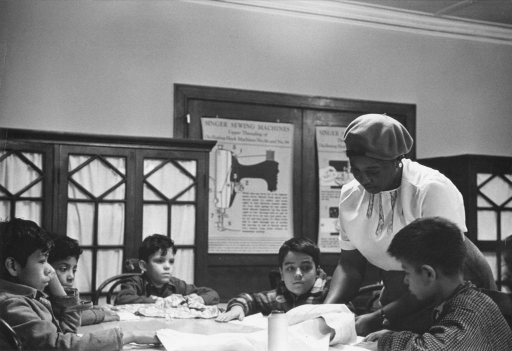 Miniature of Hull-House instructor Georgia Gardner with boys in a sewing class