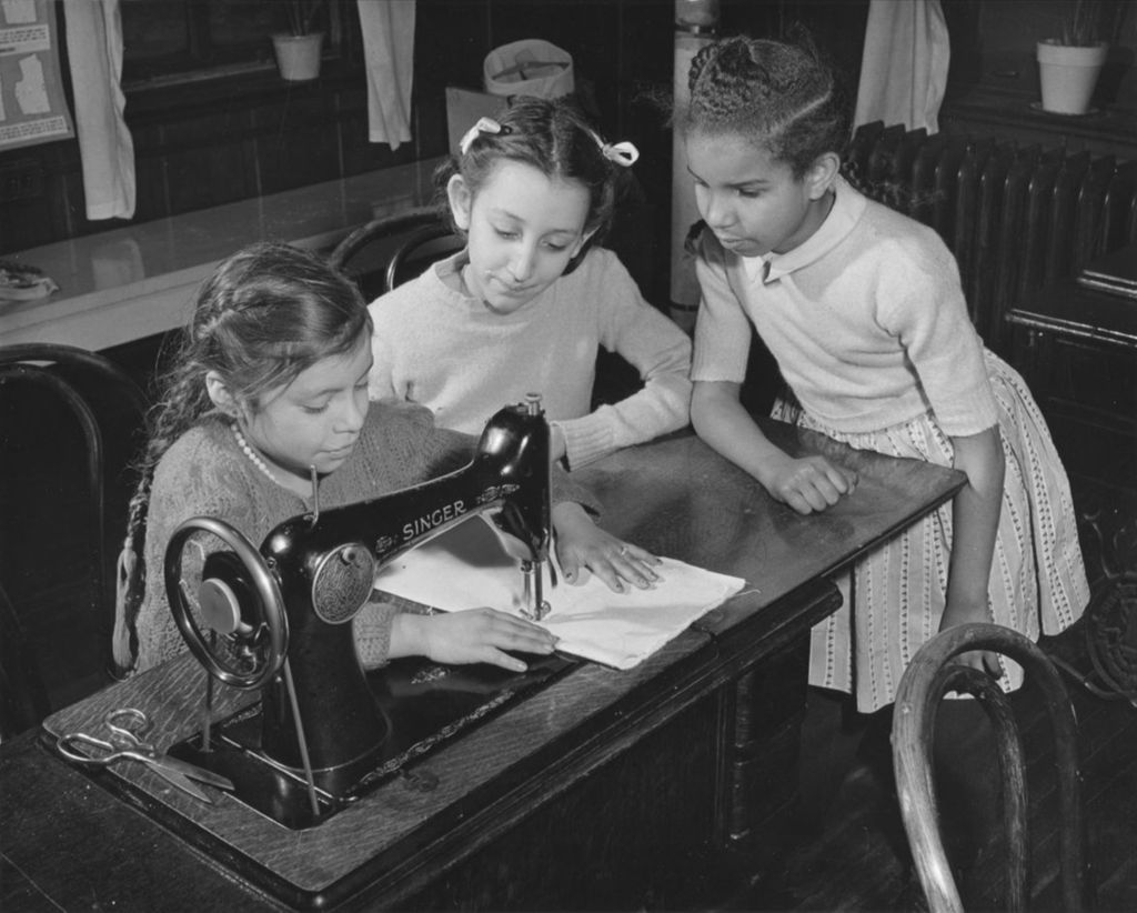 Three girls in a Hull-House sewing class