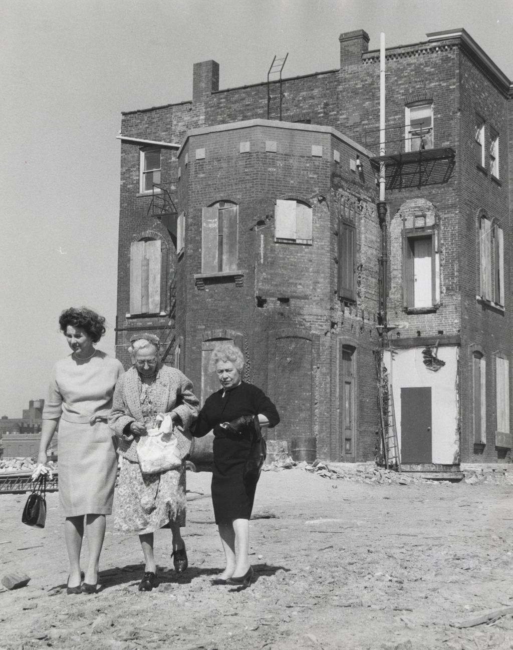 Three women walking away from Hull Mansion following the demolition of most of the rest of the Hull-House complex